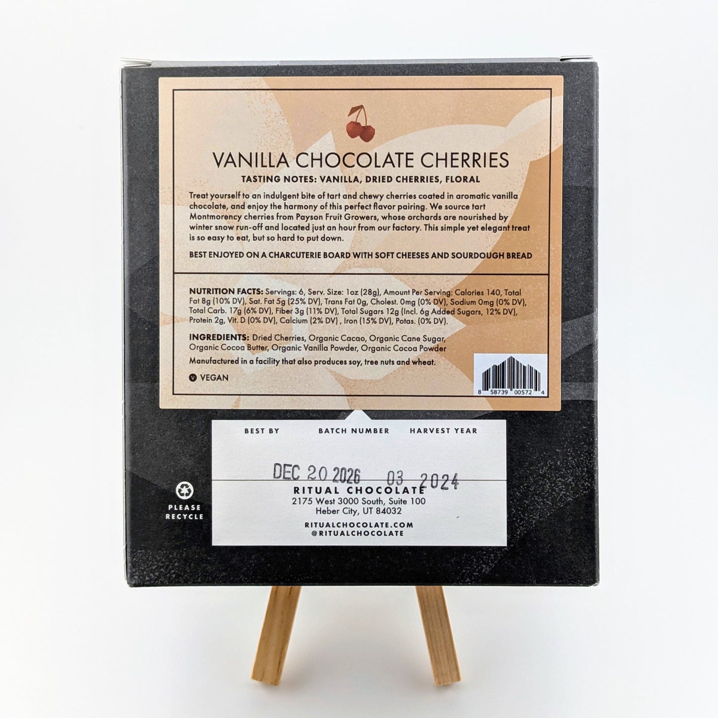 The image shows the back of a box of Ritual Vanilla Chocolate Cherries (6 oz), including tasting notes, a description, nutrition facts, Utah tart cherries as an ingredient, contact info, and vegan-friendly advice for pairing it with a charcuterie board.